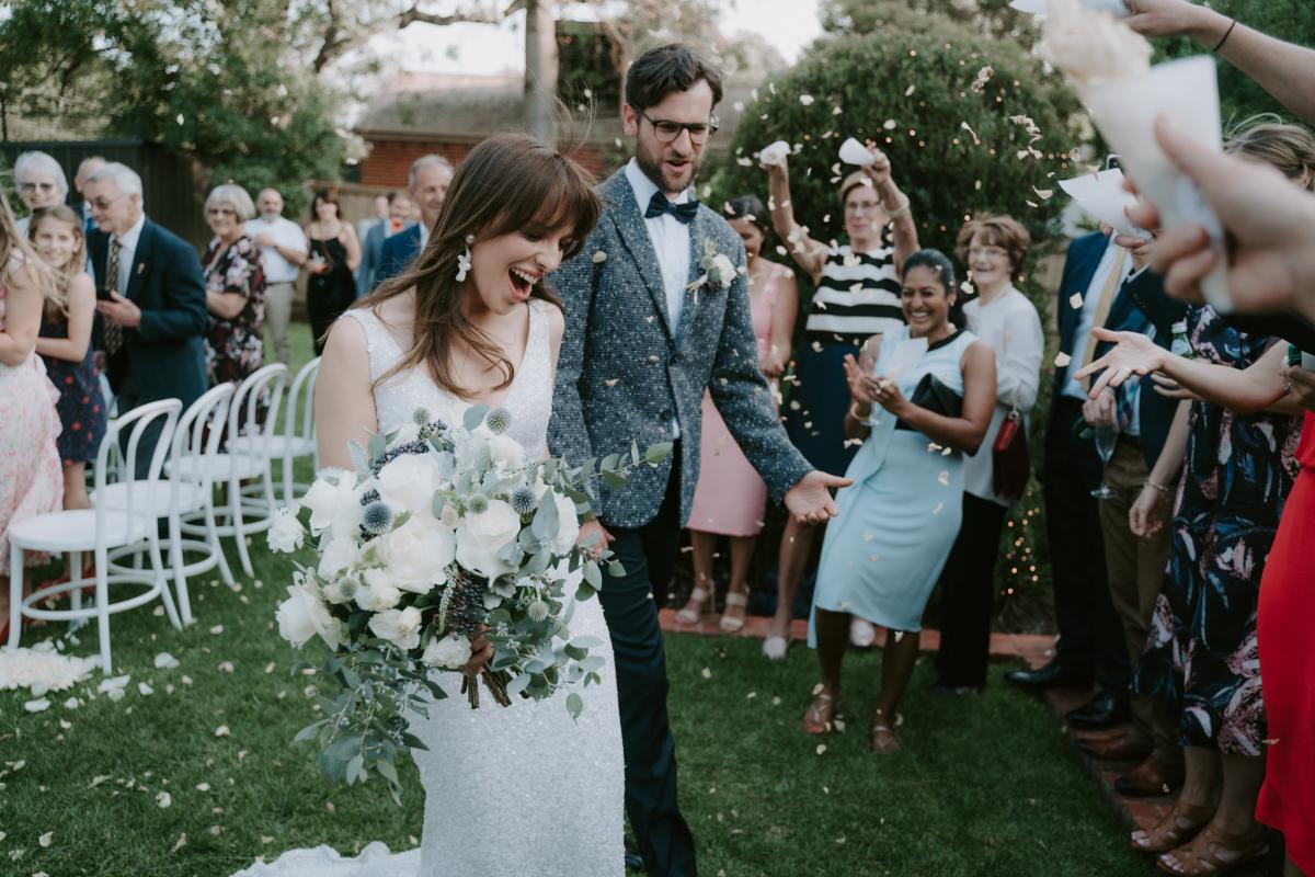 Ania in the Lola wedding dress by Karen Willis Holmes walking down aisle with native flowers
