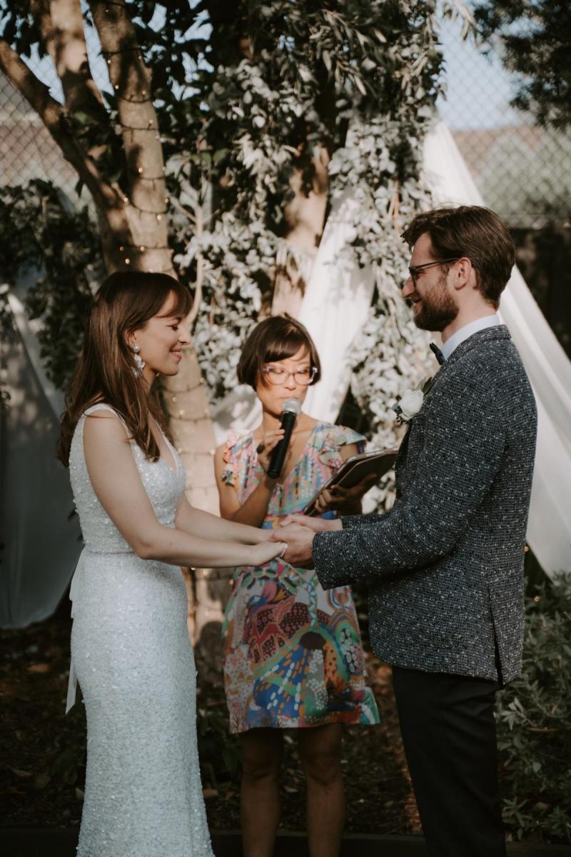 Bride Ania in Karen Willis Holmes Lola Wedding dress at wedding reception with husband