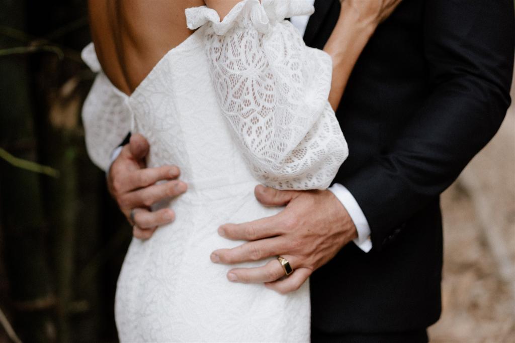 Bride wears Wild Hearts made to order lace off the shoulder Vivienne gown by Karen Willis Holmes