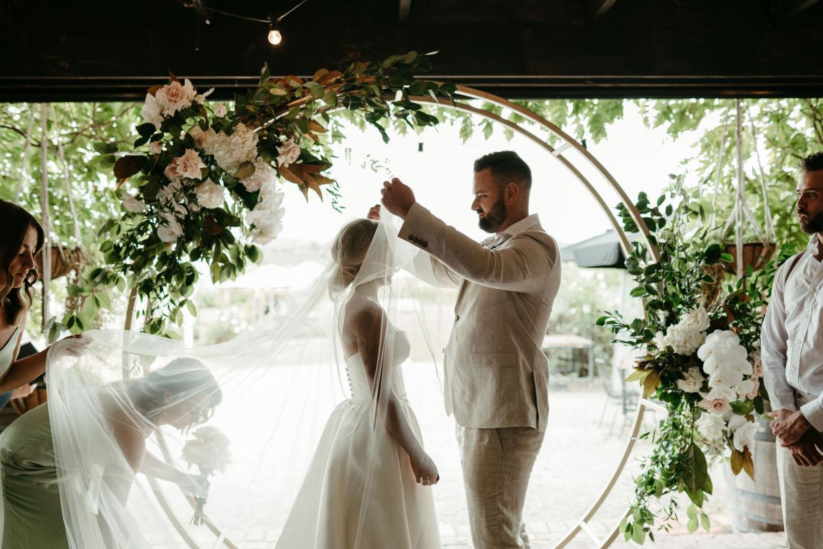 Real bride Brennah wears the Bespoke Blake Camille wedding dress; featuring a sweetheart neckline and traditional skirt by Karen Willis Holmes.