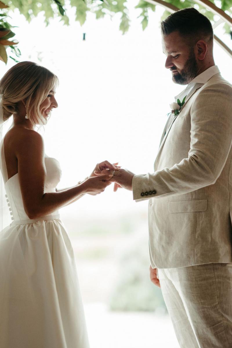 Real bride Brennah and Trent at the altar, bride wearing the Blake Camille Bespoke wedding dress by Karen Willis Holmes.