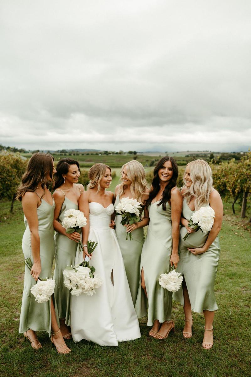 Real bride Brennah with her mint coloured bridesmaids; ladies holding white based bouquets