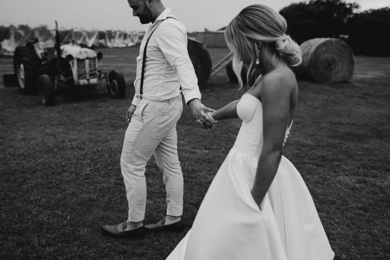 Real bride Brennah and Trent at the altar, bride wearing the Blake Camille Bespoke wedding dress by Karen Willis Holmes.