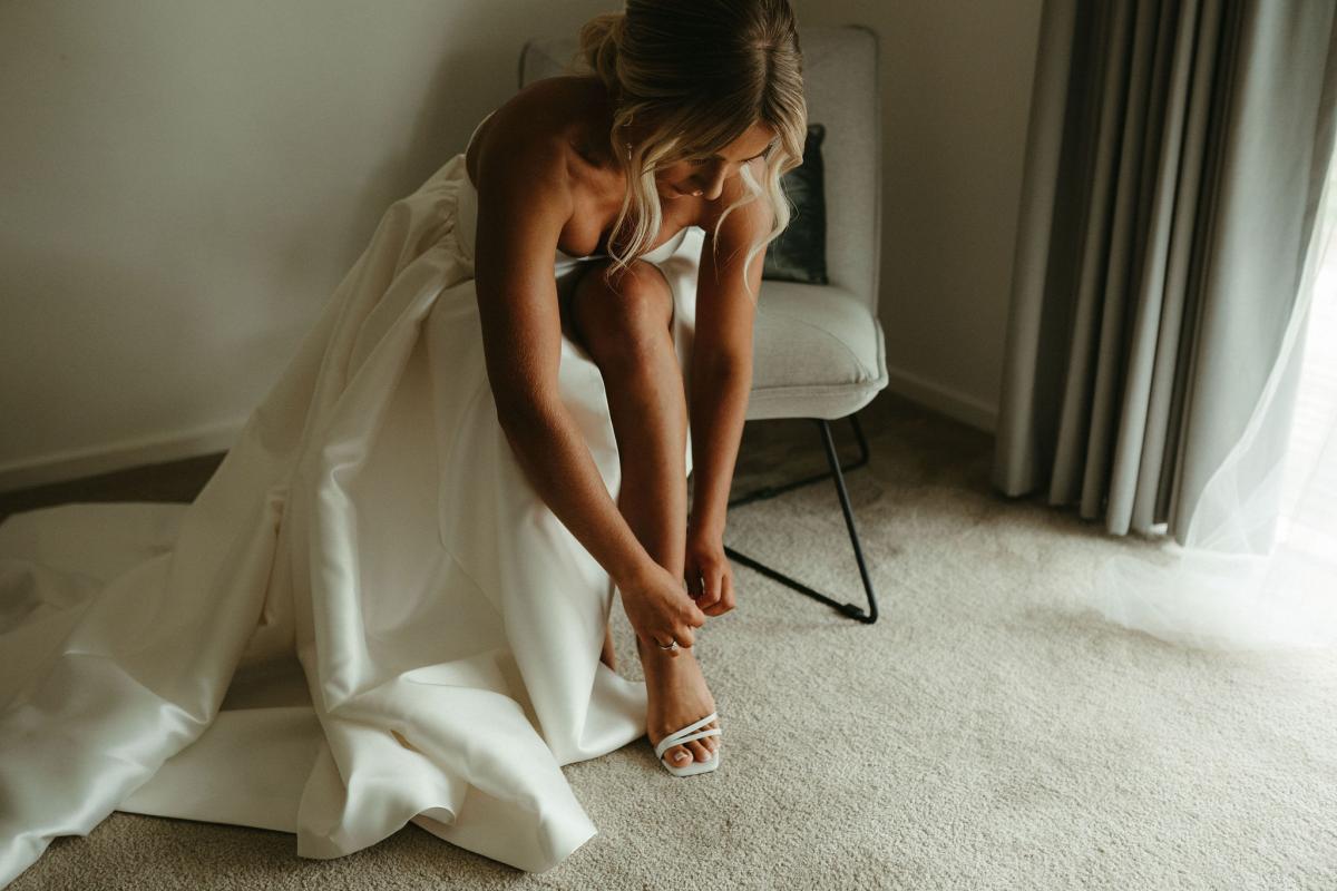 Real bride Brennah wears the Bespoke Blake Camille wedding dress; featuring a sweetheart neckline and traditional skirt by Karen Willis Holmes.