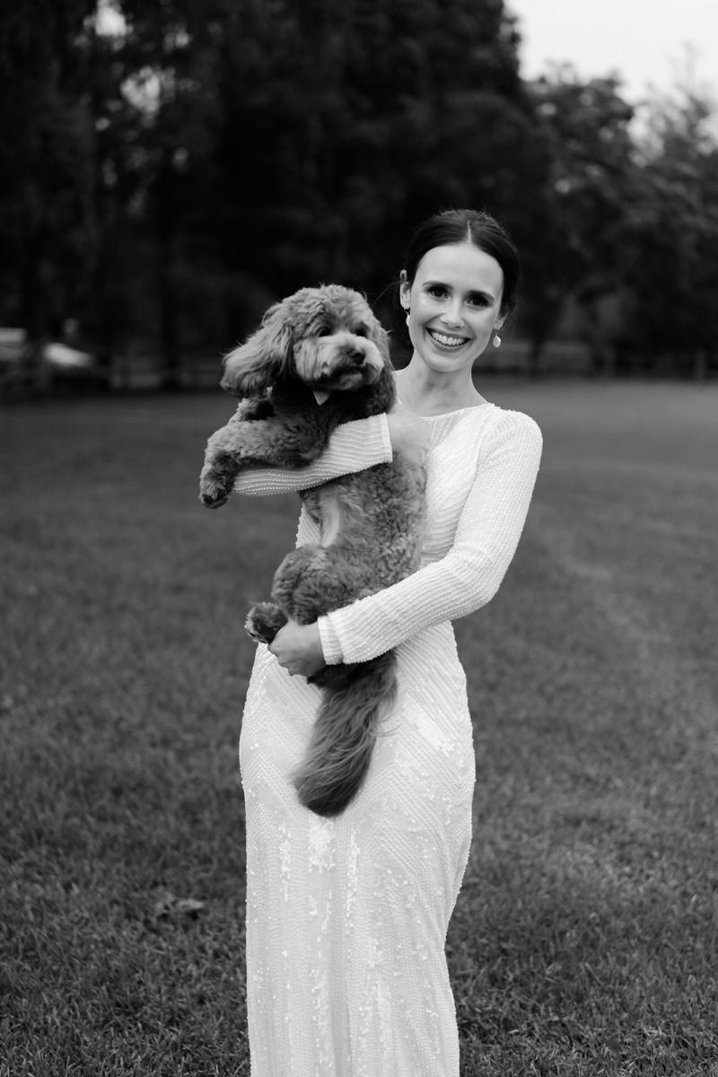 B&W image of Anna with her dog. Wearing the Cassie wedding dress by Karen Willis Holmes.