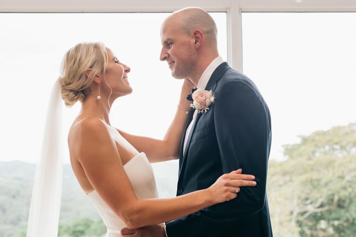 KWH bride Samantha and husband Adam share an intimate moment; bride wears the Esther gown with a one tier veil.