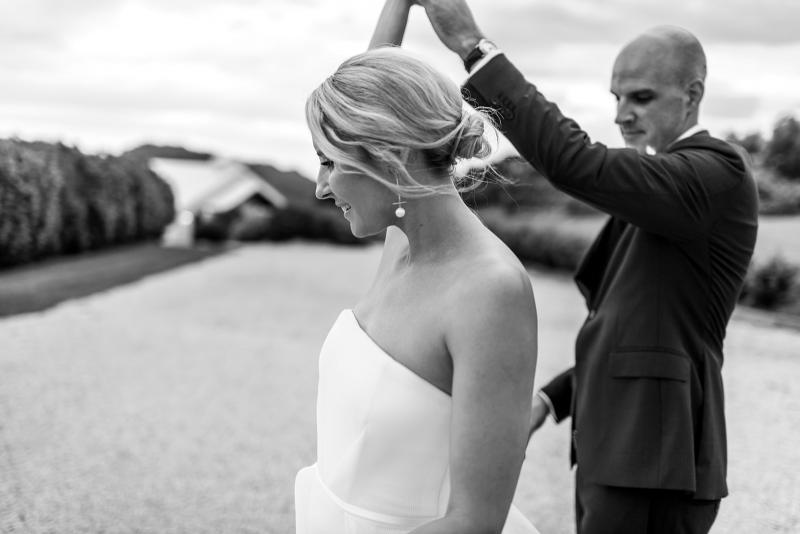 KWH bride Samantha and husband Adam at their ceremony; Samantha wears the strapless Esther wedding dress with long train.