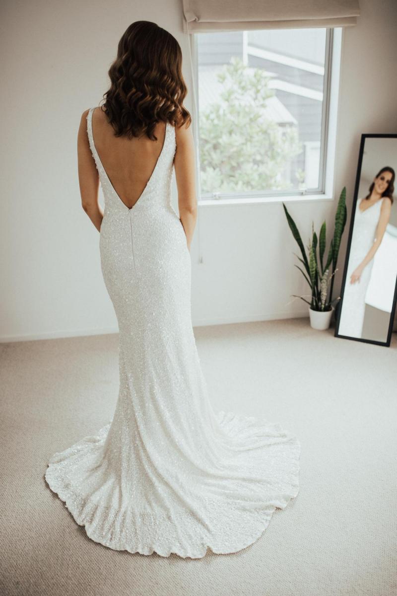 KWH real bride Tash looking in the mirror wearing our Lola gown with a low v-back.
