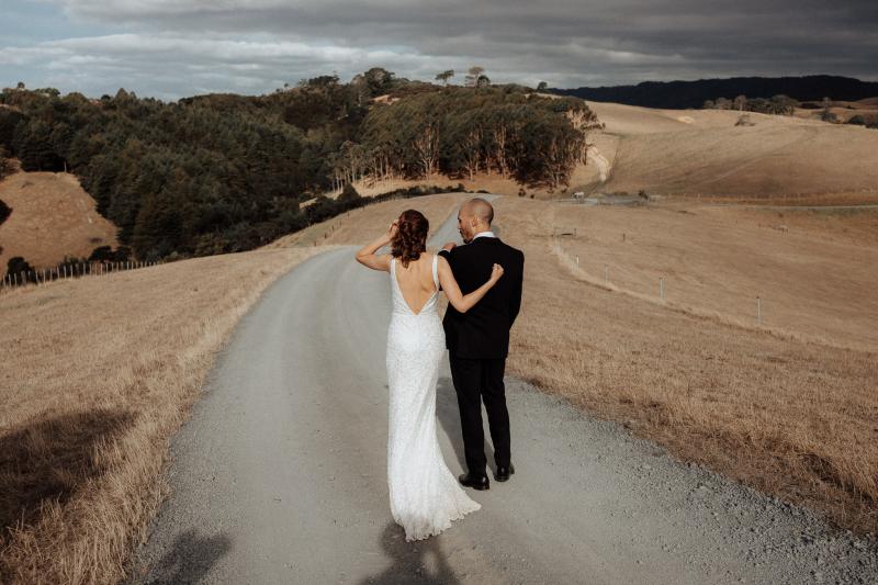 KWH real bride Tash looking in the mirror wearing our Lola gown with a low v-back.