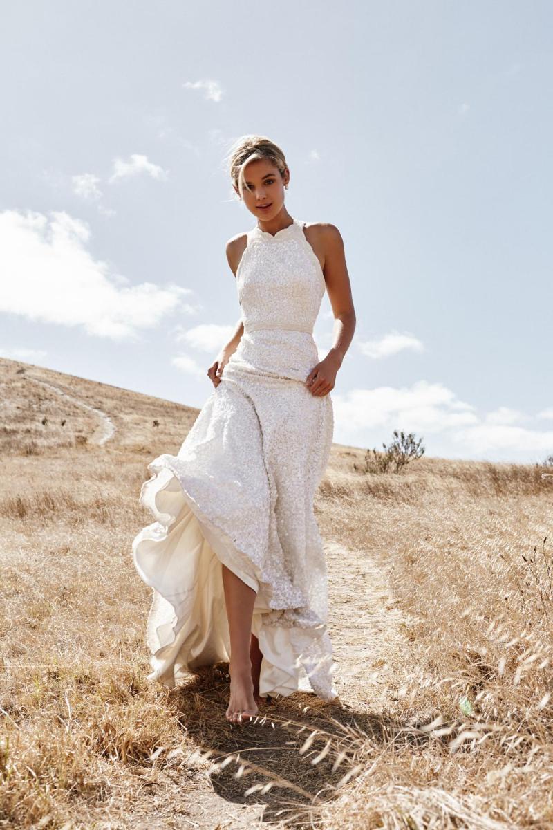 Model wears Cindy halterneck neckline wedding dress style in sequined fabric by Karen Willis Holmes