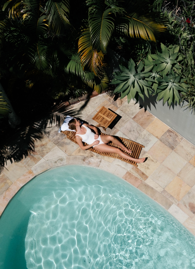 Couple sitting in spa with wine best honeymoon destinations Australia Cape Byron Retreat