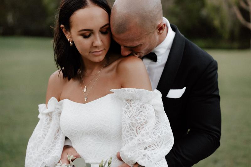 Real bride Lidia wears the Vivienne wedding dress, a lace wedding dress with balloon sleeves and dramatic train by Karen Willis Holmes for the boho bride