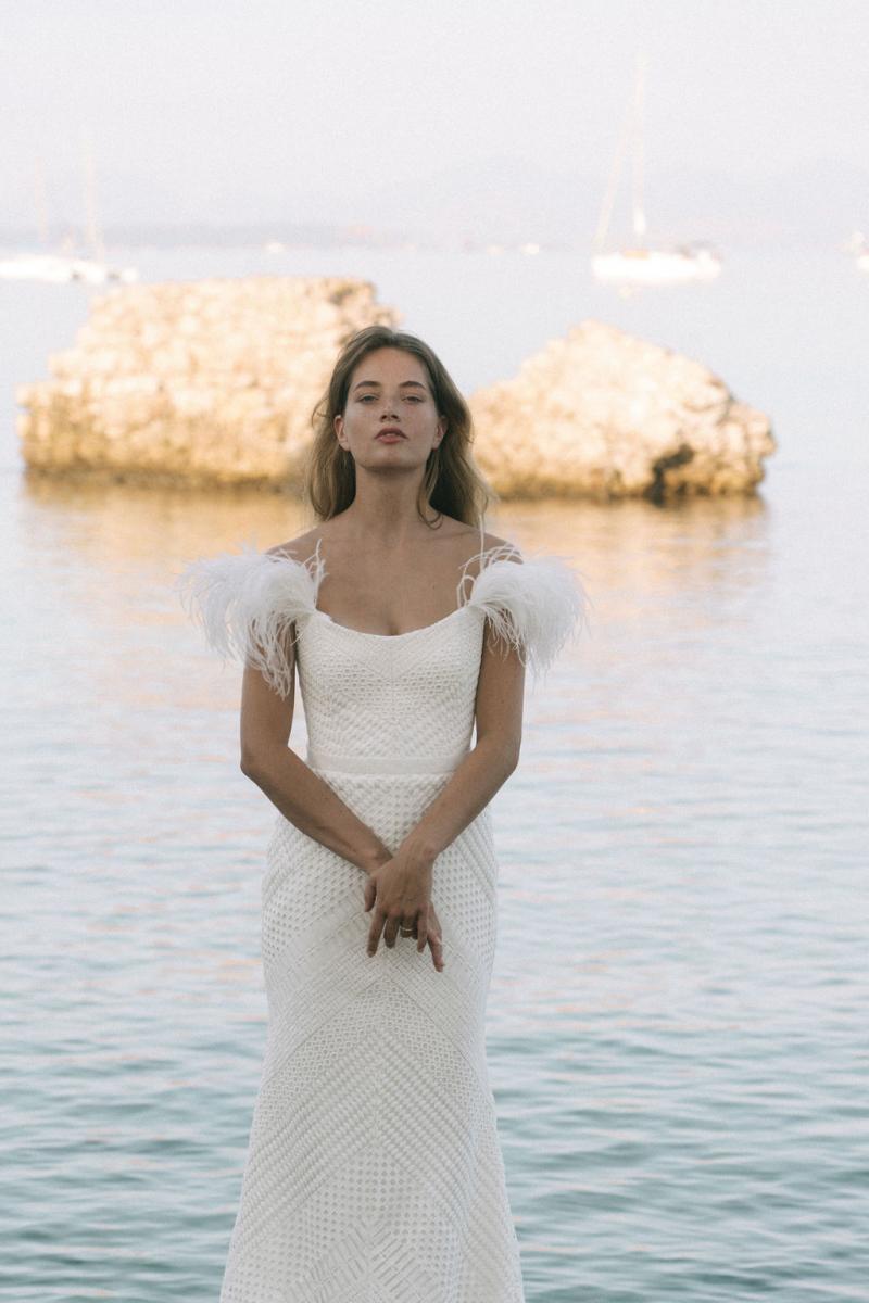 Model Ben Simmons wears the Annabelle wedding dress, a Giupure lace and Ostrich feather gown from the Elope collection by Karen Willis Holmes.