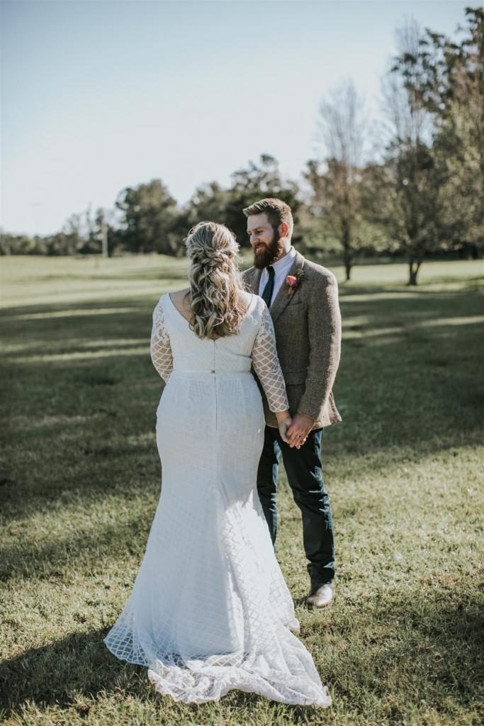 Curvy real bride Lucy wears the Bobby gown; a modern lace wedding dress with custom sleeves by Karen Willis Holmes.