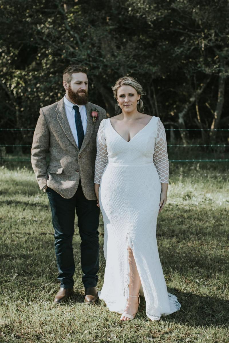 Curvy real bride Lucy wears the Bobby gown to wedding reception; a modern lace wedding dress with custom sleeves by Karen Willis Holmes.