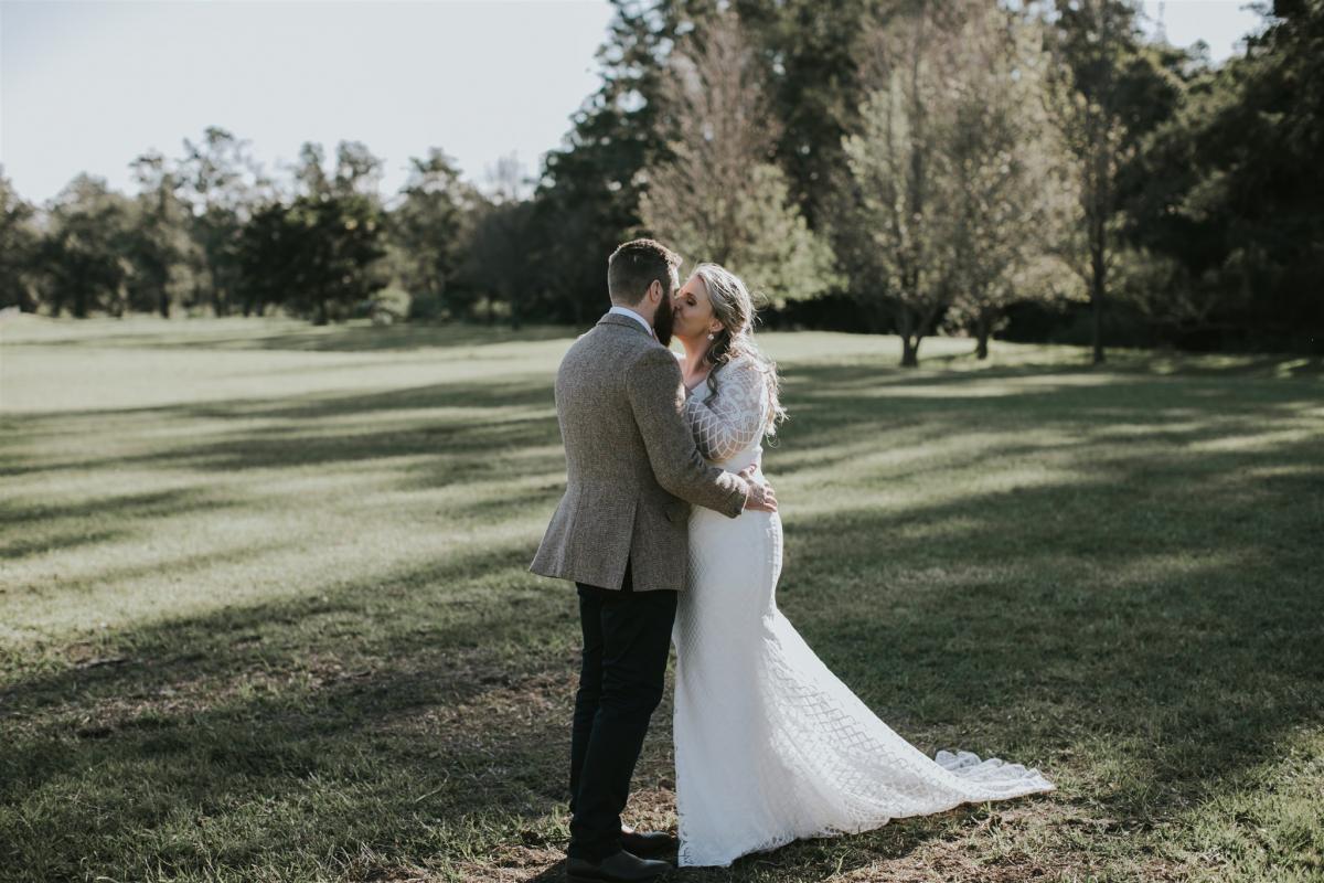 Curvy real bride Lucy wears the Bobby gown; a modern lace wedding dress with custom sleeves by Karen Willis Holmes.