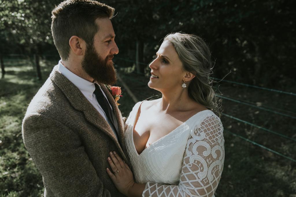 Curvy real bride Lucy wears the Bobby gown; a modern lace wedding dress with custom sleeves by Karen Willis Holmes.