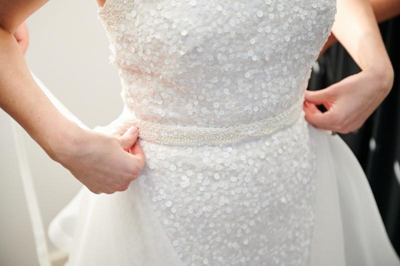 Real bride Claire getting ready for her Balmoral Beach wedding, wearing the Cindy gown, a beaded halterneck wedding dress by Karen Willis Holmes.