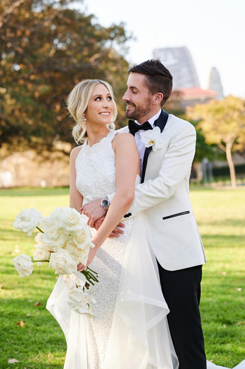 Real bride Claire wears the Cindy gown, a beaded halterneck wedding dress by Karen Willis Holmes to her Sydney wedding.