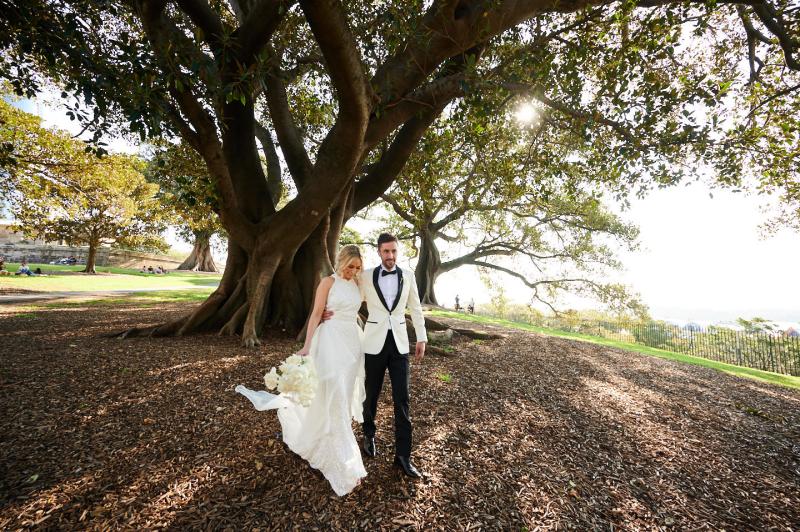 Real bride Claire wears the Cindy gown, a beaded halterneck wedding dress by Karen Willis Holmes to her Sydney wedding.