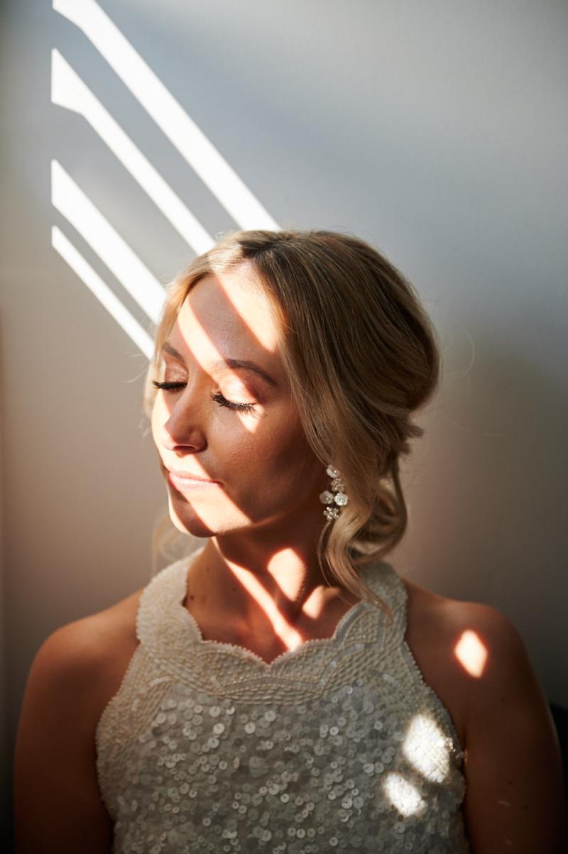 Real bride Claire getting ready for her Balmoral Beach wedding, wearing the Cindy gown, a beaded halterneck wedding dress by Karen Willis Holmes.