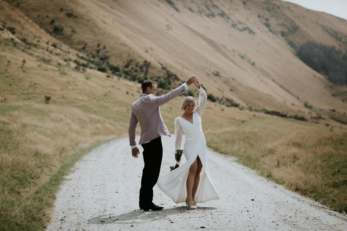 KWH real bride Lauren dancing with husband Will. Bride wears the Nikki, long sleeved, wedding dress.