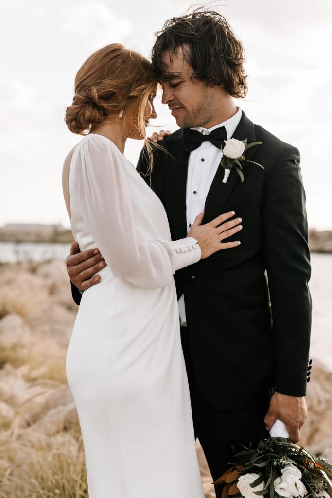 Real bride Shannon and her hubby on their wedding day, bride wears the long sleeved Nikki gown by Karen Willis Holmes.