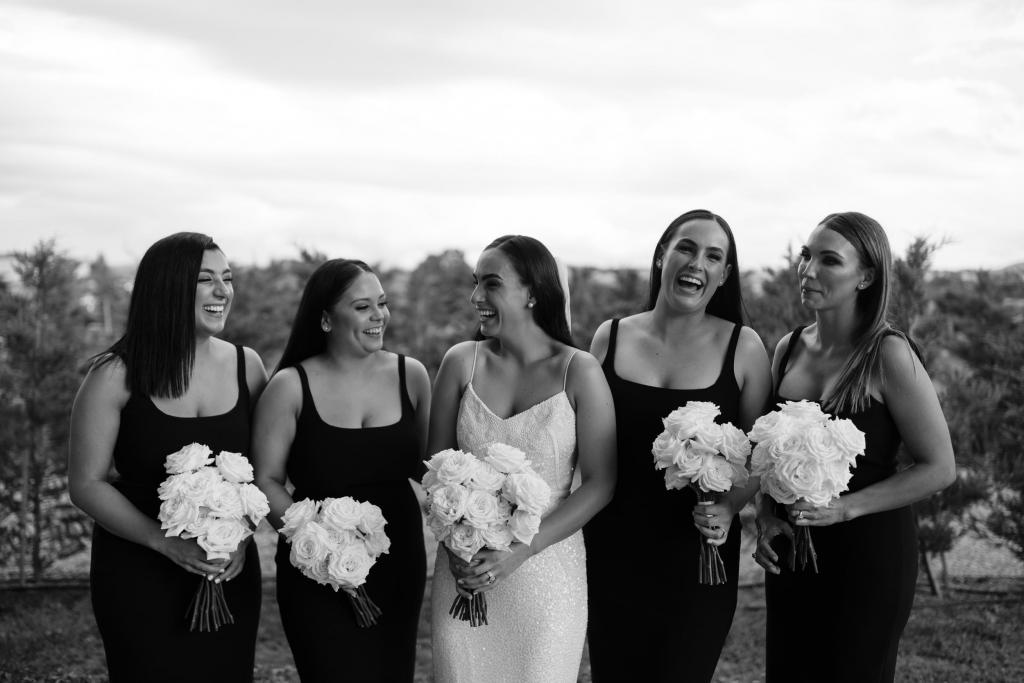Real bride Lucy with bridesmaids in black for her winery wedding, wearing the Addison gown; a beaded wedding dress by Karen Willis Holmes.