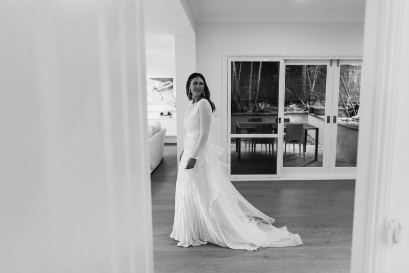 Real bride Penelope wears the Cassie gown; a long sleeve art deco beaded wedding dress from the Luxe collection by Karen Willis Holmes.