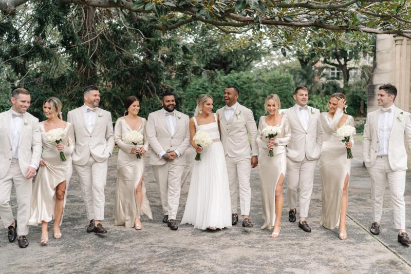 Real bride Maddi wears the Daisy gown, a non-conventional wedding dress with a pleated skirt and panel waist by Karen Willis Holmes, bride wearing a long veil.