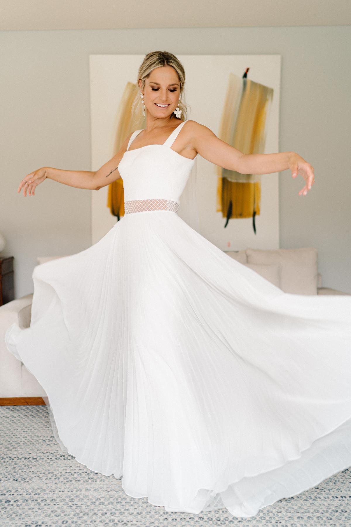 Real bride Maddi getting ready for Vogue wedding with bridesmaids; wearing the Daisy gown, a non traditional chiffon wedding dress by Karen Willis Holmes.