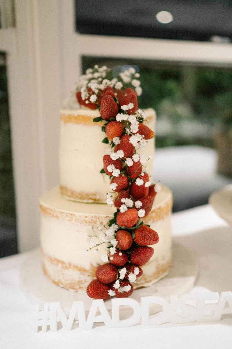 KWH Real bride Maddi and Kurley's wedding cake decorated with a simple icing and adorned with strawberries.
