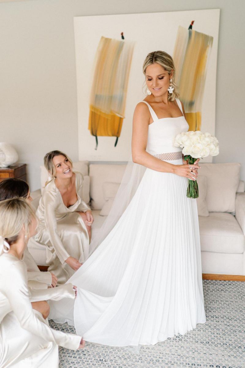 Real bride Maddi getting ready for Vogue wedding with bridesmaids; wearing the Daisy gown, a non traditional chiffon wedding dress by Karen Willis Holmes.