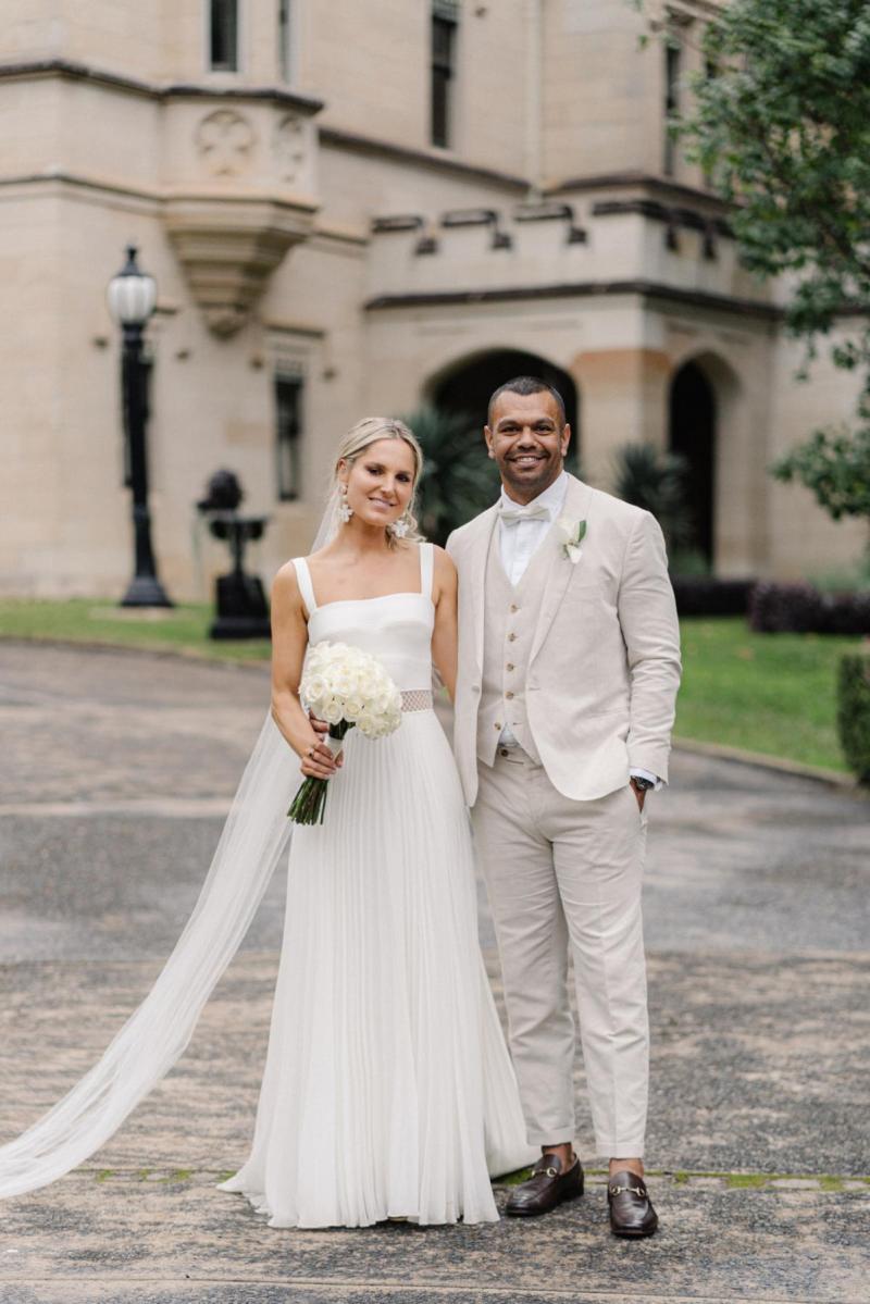 Real bride Maddi with husban Kurtley at alter, wedding featured on Vogue bridal, bride wearing the Daisy gown by Karen Willis Holmes.
