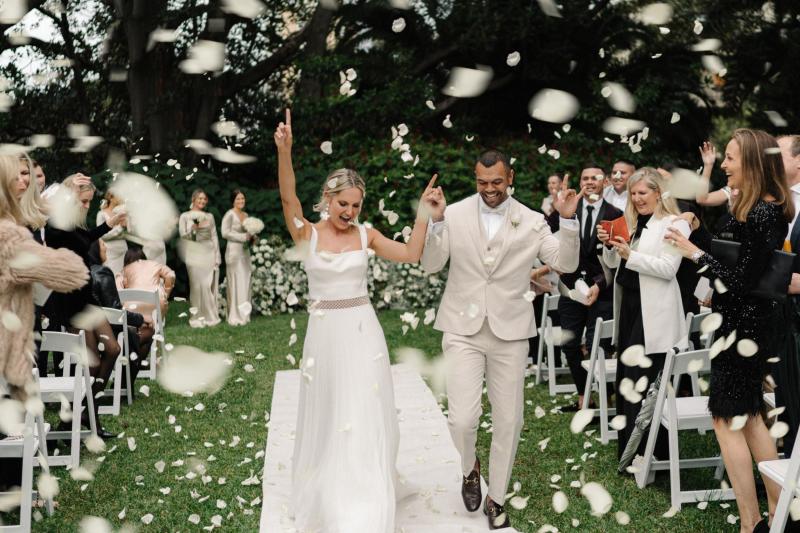 Real bride Maddi with husban Kurtley at alter, wedding featured on Vogue bridal, bride wearing the Daisy gown by Karen Willis Holmes.