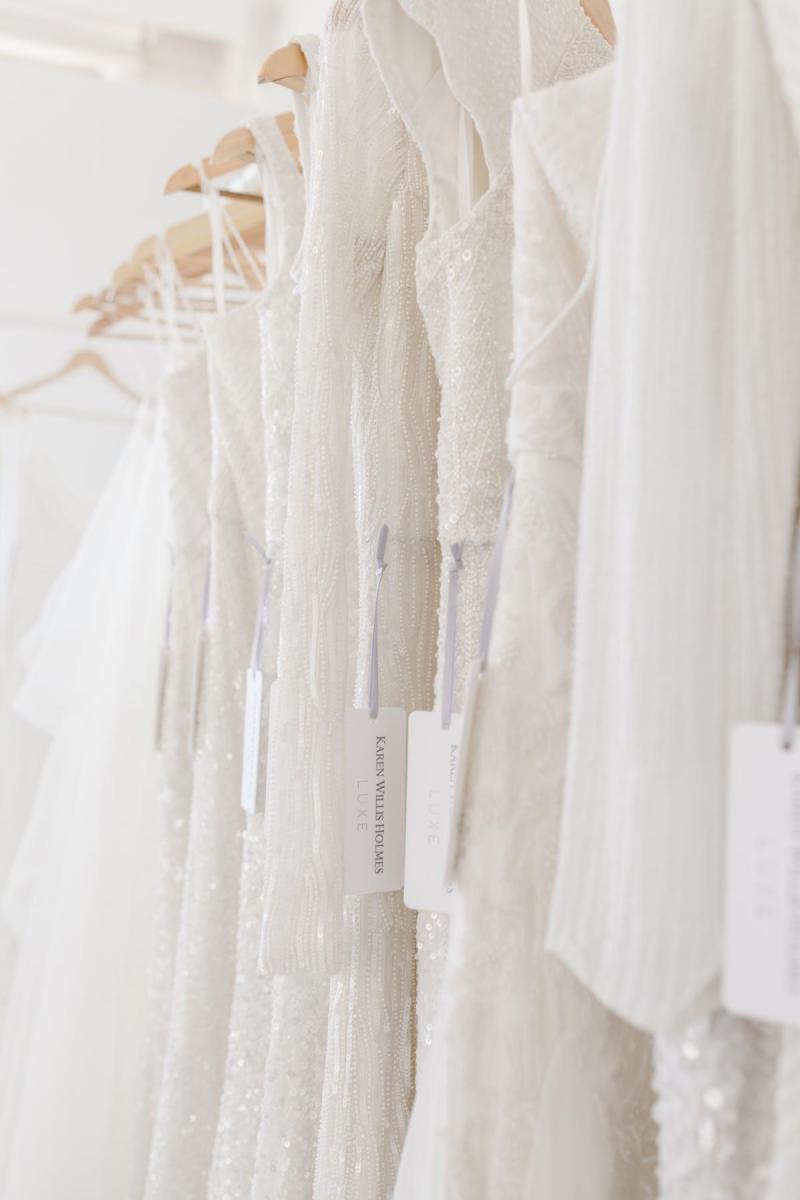 Karen Willis Holmes 20th Anniversary of Australian bridal picture of LUXE beaded wedding dresses hanging on rack