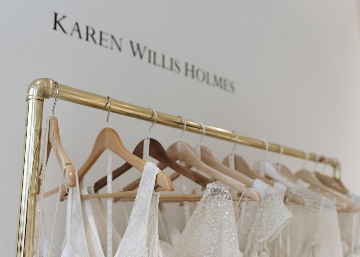 Karen Willis Holmes 20th Anniversary of Australian bridal picture of LUXE beaded wedding dresses hanging on rack