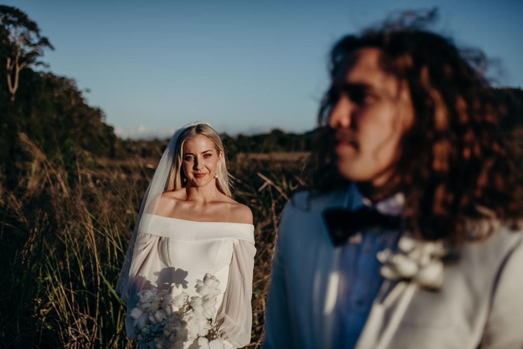 Real bride Hannah wears the Lauren gown with cut open back and off shoulder long sleeves by Karen Willis Holmes