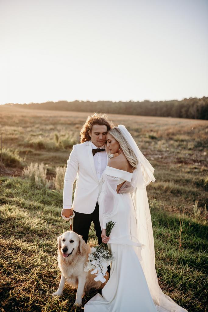 Real bride Hannah wears the Lauren gown with cut open back and off shoulder long sleeves by Karen Willis Holmes