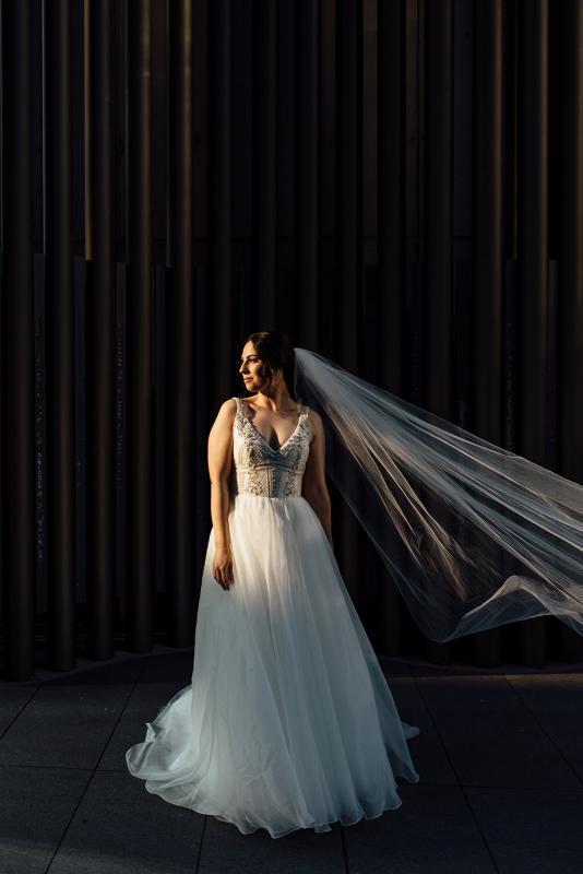 Real bride Stef wears the Sophie gown with long bridal veil; an embellished a-line bespoke wedding dress by Karen Willis Holmes.