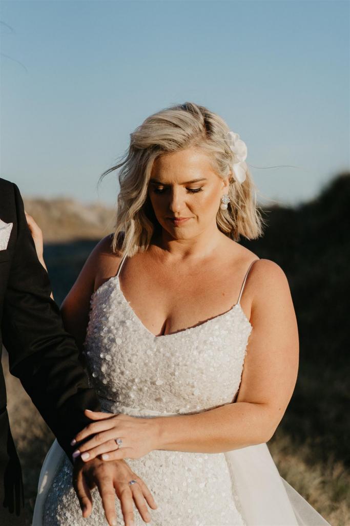 Curvy real bride Leanne wears the Anya gown; a beaded spaghetti strap wedding dress by Karen Willis Holmes.