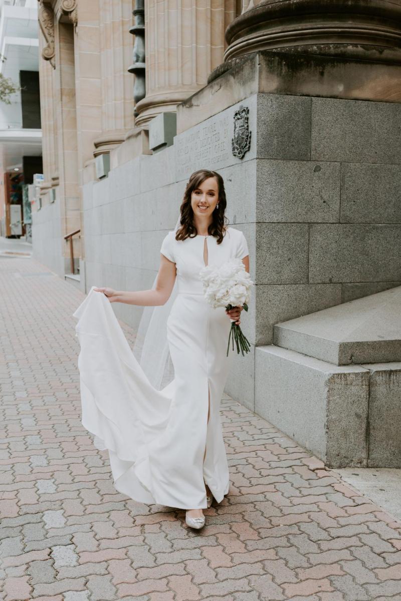 Real bride Jennifer wears the Clarissa gown, a simple cap sleeve wedding dress by Karen Willis Holmes.