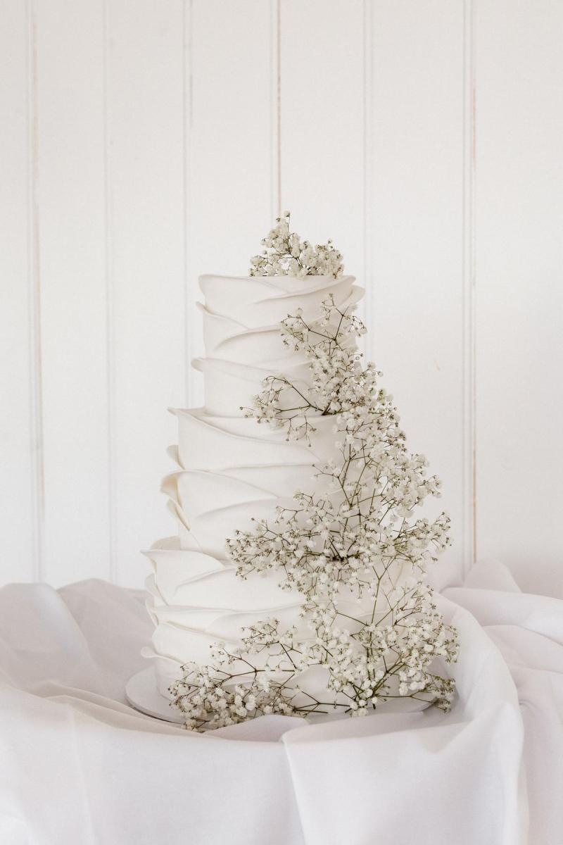 White wedding cake with baby's breath flowers at real bride Ancille's Perth wedding.