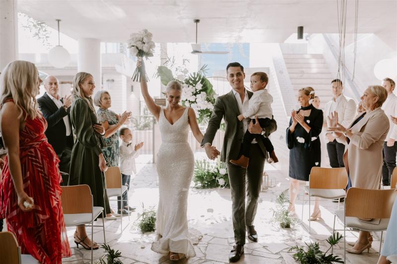 Real bride Shannon leaving her small wedding ceremony with husband, wearing the Lola gown by Karen Willis holmes.