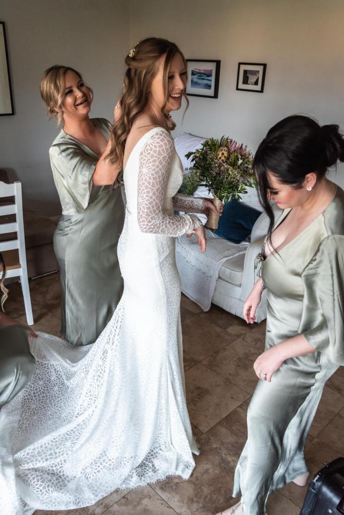Real bride Monica getting ready for small wedding ceremony, wearing the Rylie gown by Karen Willis Holmes.