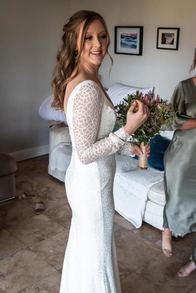 Real bride Monica getting ready for small wedding ceremony, wearing the Rylie gown by Karen Willis Holmes.