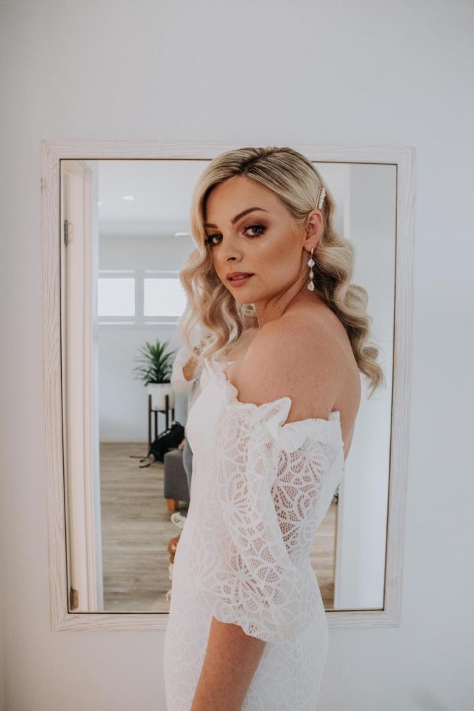 Real bride Kacie-Lee getting ready for wedding, wearing the Vivienne gown by Karen Willis Holmes; a puff sleeve boho wedding dress.