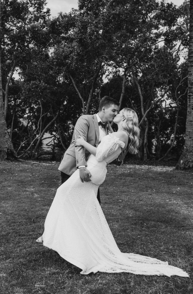 Real bride Kacie-Lee wears the Vivienne gown; a puff sleeve lace wedding dress by Karen Willis Holmes, from the Wild Hearts Collection.