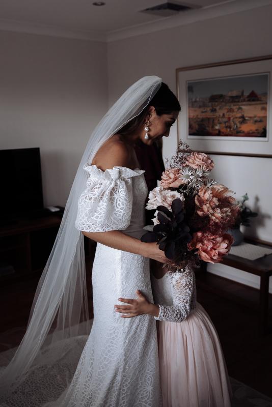 Real bride Zinovia getting ready for rustic country wedding, wearing the Vivienne gown; a puff sleeve wedding dress with modern lace by Karen Willis Holmes.