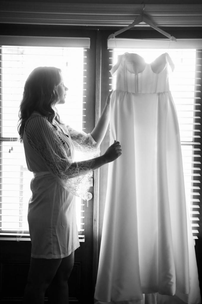 Real bride Valentina getting ready for Melbourne wedding, holding the Blake Camille gown by Karen Willis Holmes.
